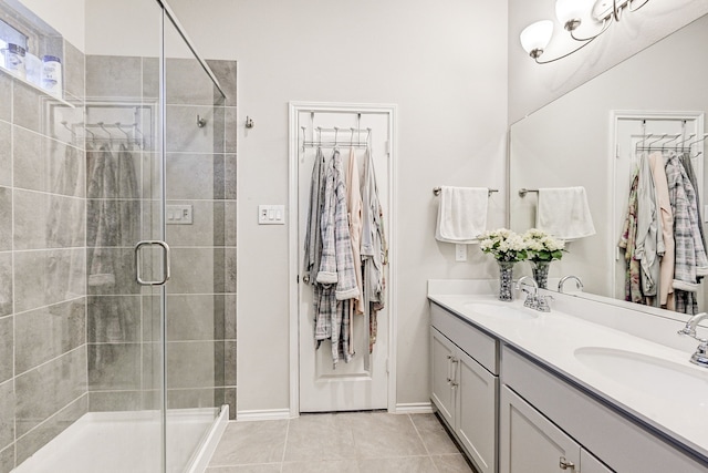 bathroom with tile patterned floors, vanity, and a shower with shower door