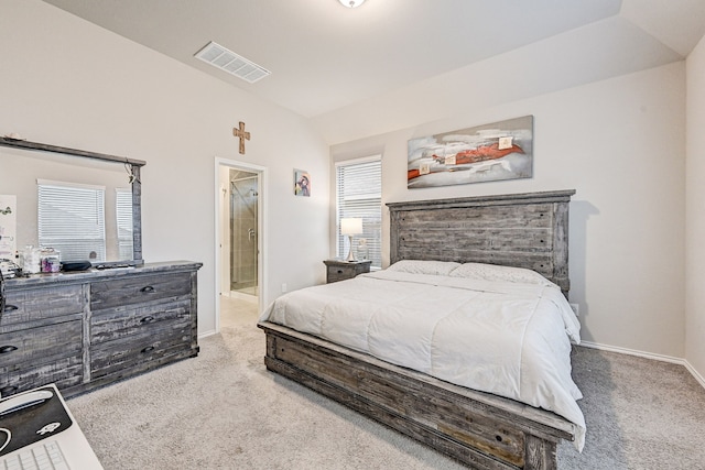 bedroom featuring light carpet, connected bathroom, vaulted ceiling, and multiple windows