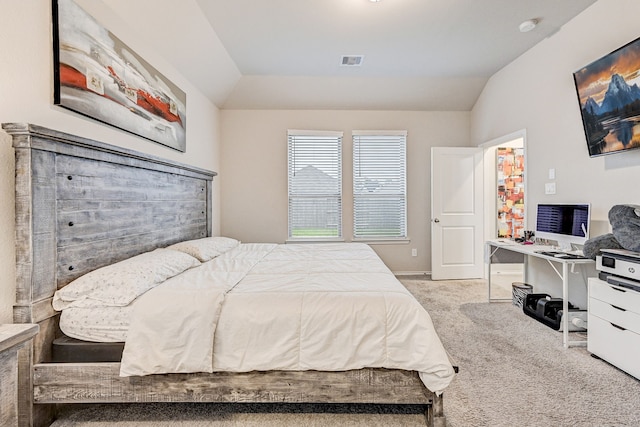 bedroom featuring vaulted ceiling and light carpet