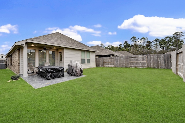 rear view of property with ceiling fan, a lawn, and a patio area