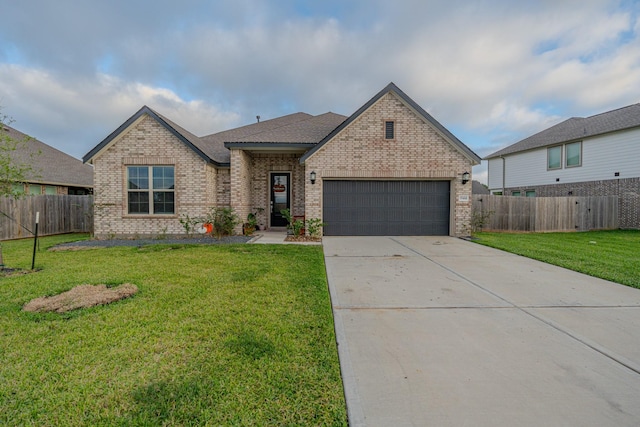 view of front of property with a front yard and a garage