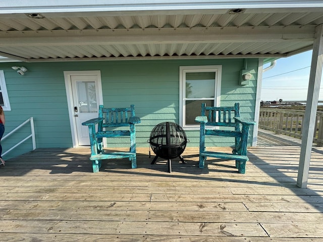 wooden deck with an outdoor fire pit