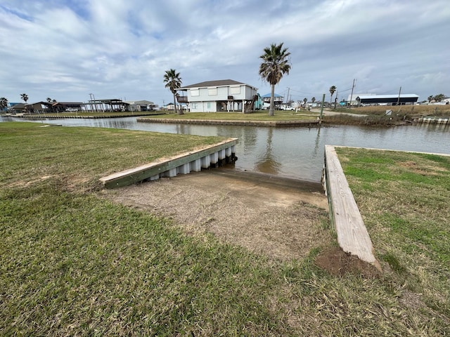 dock area with a water view and a lawn