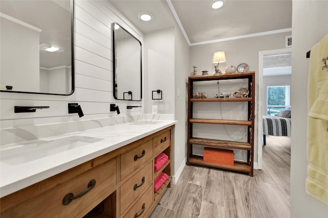 bathroom with vanity and ornamental molding