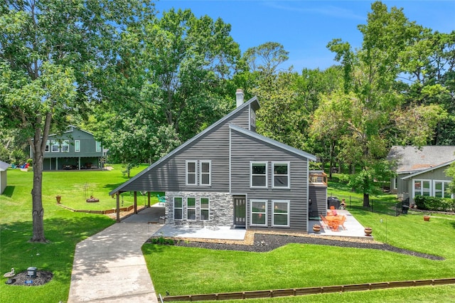 back of house featuring a yard and a patio area