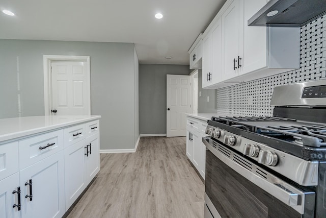 kitchen with stainless steel gas stove, white cabinetry, exhaust hood, and tasteful backsplash