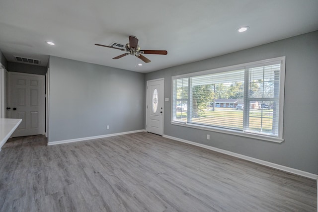 spare room with ceiling fan, light hardwood / wood-style flooring, and a healthy amount of sunlight