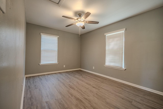 unfurnished room with ceiling fan and wood-type flooring