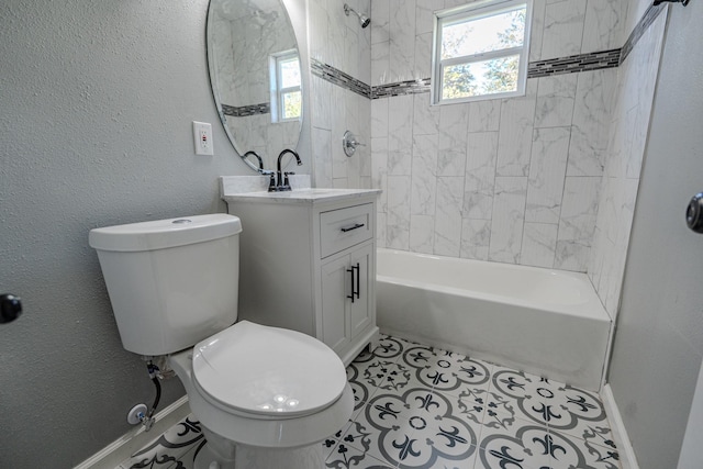 full bathroom featuring tile patterned flooring, vanity, toilet, and tiled shower / bath