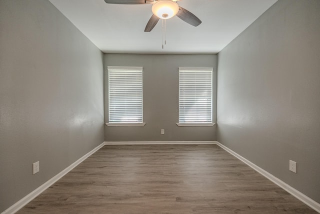 unfurnished room featuring hardwood / wood-style floors and ceiling fan