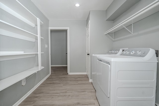 laundry room with light hardwood / wood-style floors and independent washer and dryer