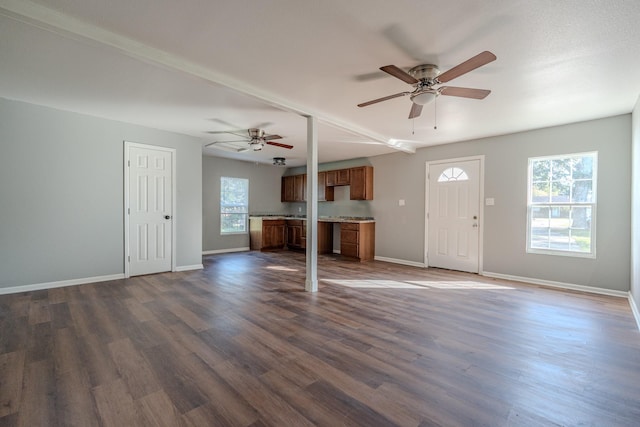 unfurnished living room with dark hardwood / wood-style floors and ceiling fan