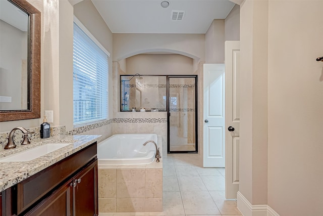 bathroom featuring vanity, tile patterned flooring, and plus walk in shower