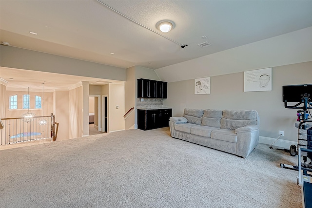 carpeted living room featuring vaulted ceiling