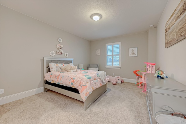 bedroom featuring light colored carpet and a textured ceiling