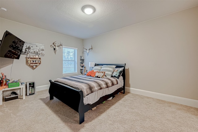 bedroom with carpet and a textured ceiling