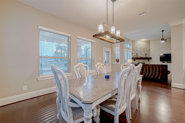 dining room featuring a wealth of natural light, dark wood-type flooring, and a notable chandelier