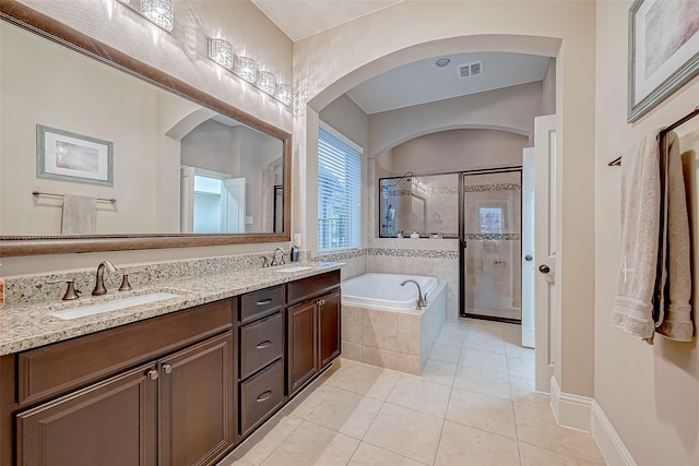 bathroom with tile patterned floors, vanity, and independent shower and bath