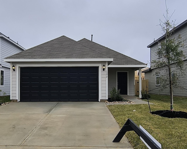 ranch-style house with a front yard and a garage