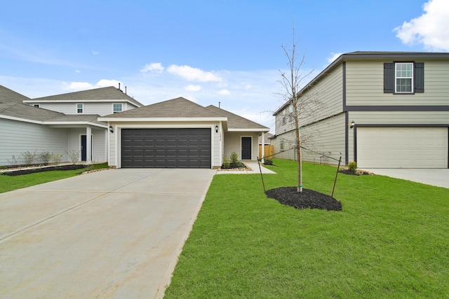 view of front of house featuring driveway, a garage, and a front yard