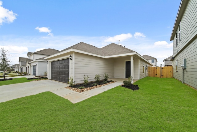 view of front of property with an attached garage, a front yard, a gate, fence, and driveway