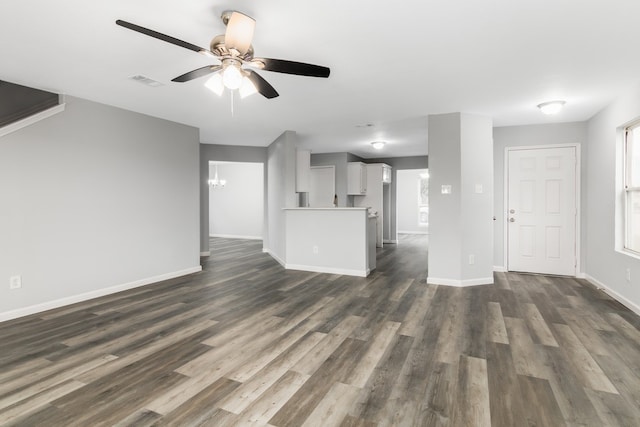 unfurnished living room with ceiling fan and dark hardwood / wood-style floors