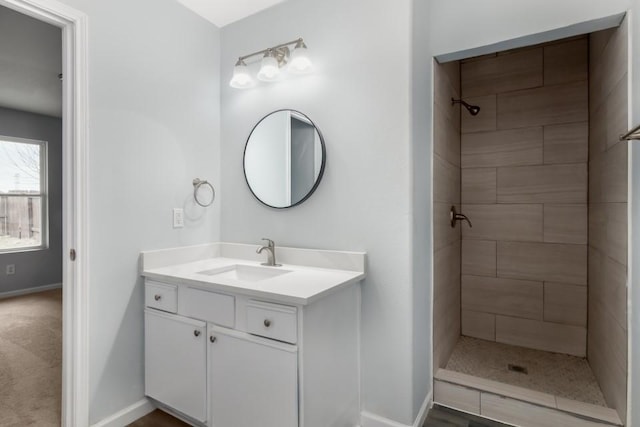 bathroom featuring vanity and a tile shower