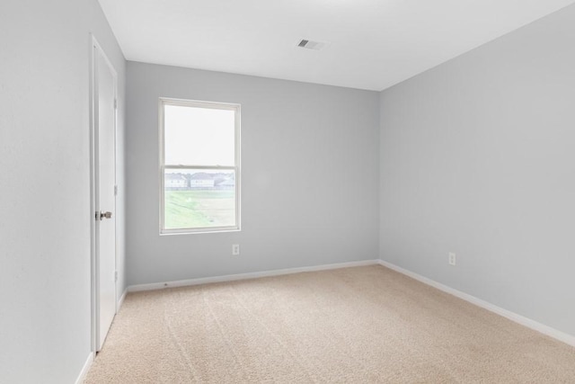 unfurnished room with light carpet