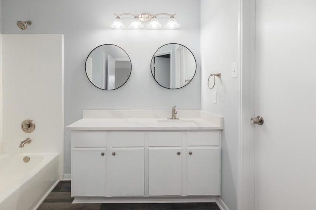 bathroom featuring bathing tub / shower combination, wood-type flooring, and vanity