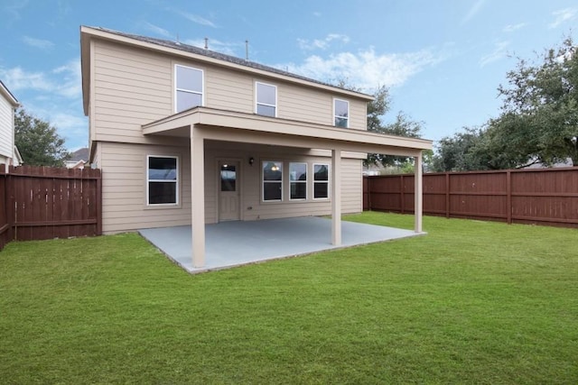 rear view of property with a lawn and a patio