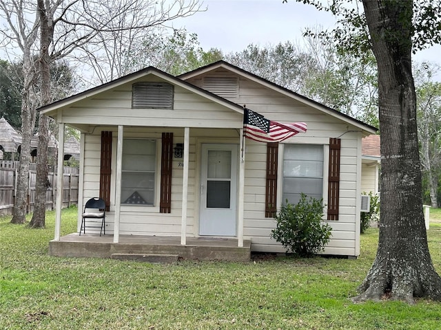 bungalow with a front yard and a porch