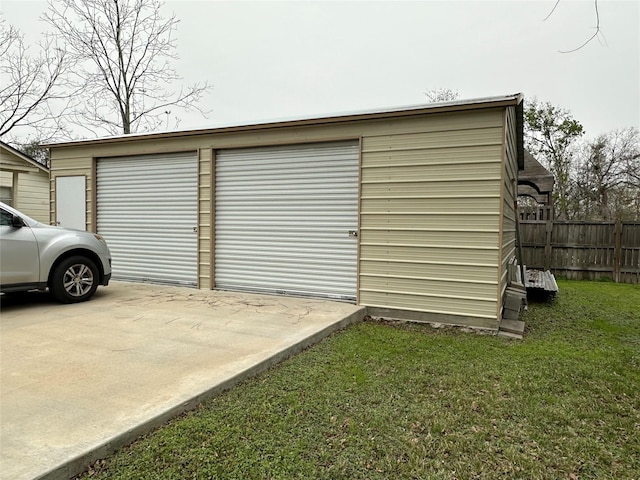 garage featuring a lawn