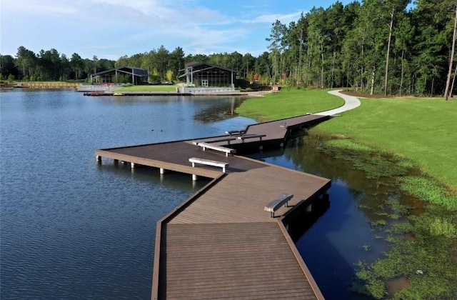 view of dock featuring a water view and a lawn