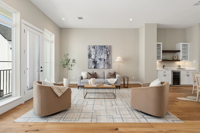 living room featuring light wood-type flooring and wine cooler