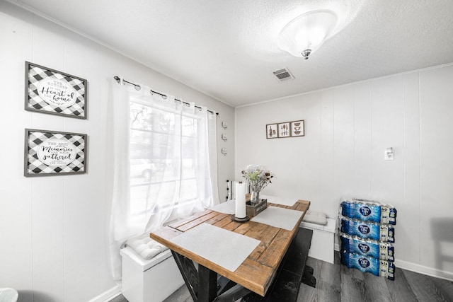 dining space featuring a textured ceiling and dark hardwood / wood-style floors