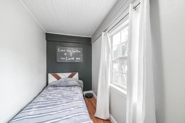 bedroom featuring multiple windows and hardwood / wood-style floors