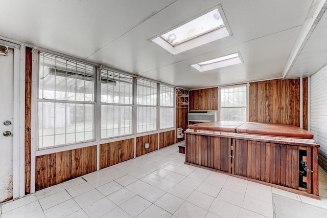 kitchen featuring wood walls and a skylight