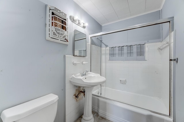 full bathroom with sink, toilet, ornamental molding, and tiled shower / bath