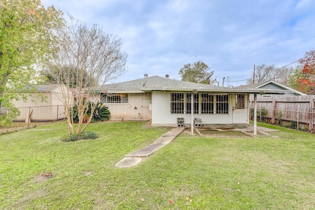 rear view of property with a yard