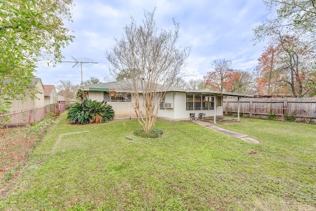 rear view of property with a yard