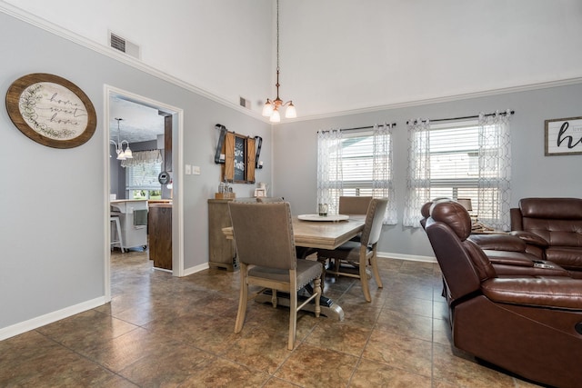 dining room with crown molding and an inviting chandelier