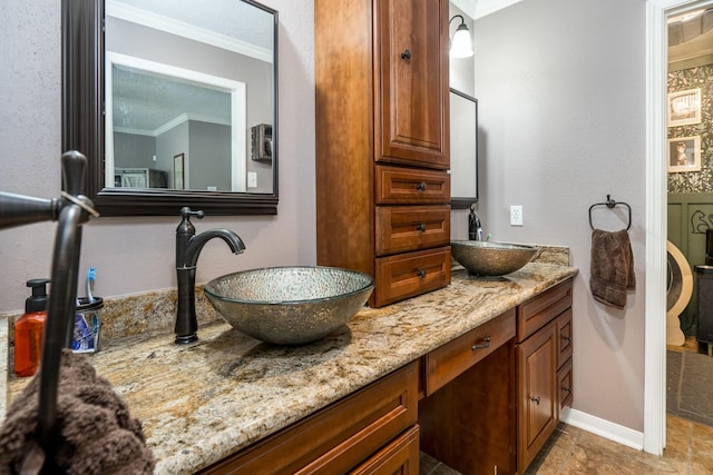 bathroom featuring ornamental molding and vanity