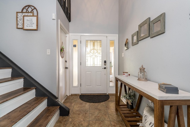 tiled foyer entrance with a high ceiling