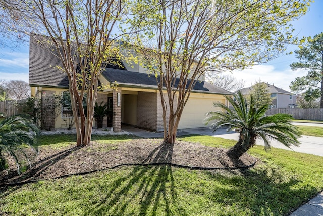 view of front of house featuring a garage and a front lawn