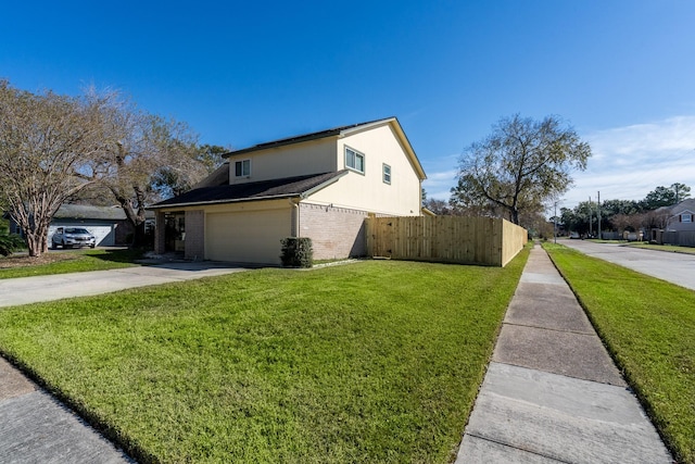 view of home's exterior with a garage and a lawn