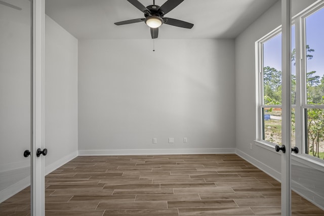 unfurnished room featuring ceiling fan, light hardwood / wood-style floors, and french doors