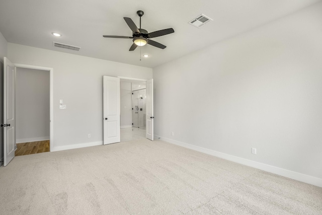 unfurnished bedroom with ceiling fan and light colored carpet