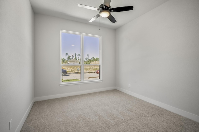 carpeted empty room with ceiling fan and plenty of natural light