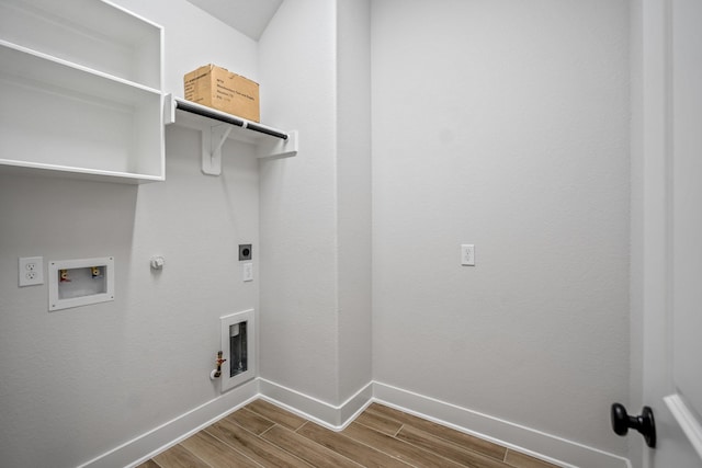 laundry area featuring electric dryer hookup, gas dryer hookup, hardwood / wood-style floors, and washer hookup