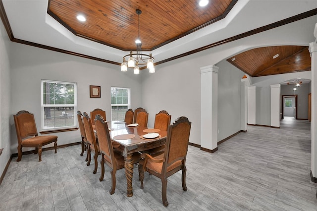 dining space featuring light wood-type flooring, a tray ceiling, ornate columns, and wood ceiling